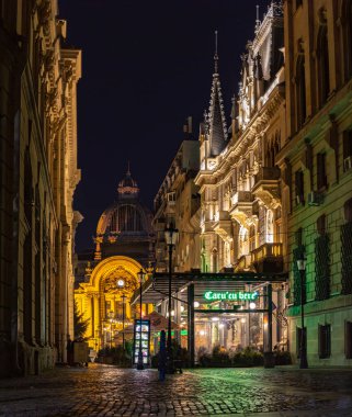 A picture of the Palace of the Deposits and Consignments and the Stavropoleos Street at night.