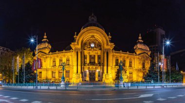 A picture of the Palace of the Deposits and Consignments at night.