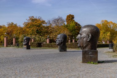 A picture of multiple head statues of the European Union Founders' Monument, in Bucharest.