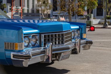 A picture of the front side of a light blue Cadillac Eldorado.
