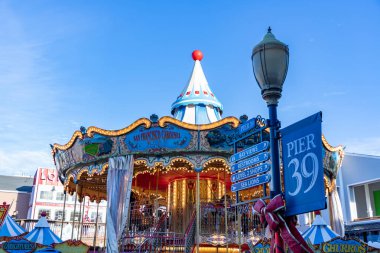 39. rıhtımın simgesel renkli atlıkarıncalarının yanında bir resim..