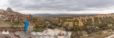 Uchisar kasabasının, Güvercin Vadisi 'nin ve bulutlu bir günde Goreme Ulusal Parkı' nın panorama resmi..