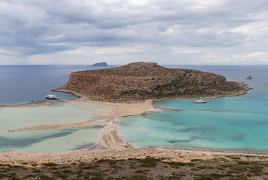 A picture of the blue water of Balos Beach and the nearby landscape of the Gramvousa Peninsula.