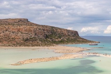 A picture of the blue water of Balos Beach and the nearby landscape of the Gramvousa Peninsula.