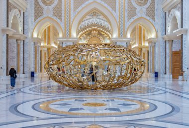 A picture of a golden sculpture at the East Hall of Qasr Al Watan. clipart