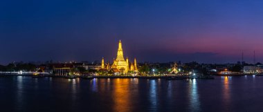 A picture of the Wat Arun Temple at night. clipart