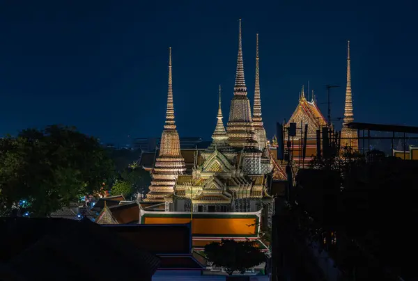 stock image A picture of the spires of the Wat Pho Temple at night.