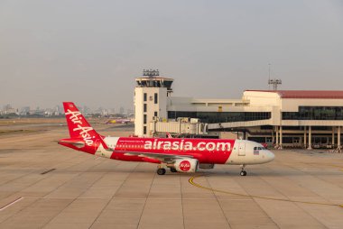 A picture of an AirAsia plane while taxiing. clipart