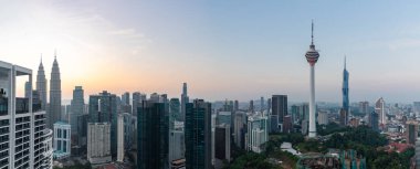 Kuala Lumpur 'un fotoğrafı, en solda Petronas İkiz Kuleleri, ve sağda Menara Kuala Lumpur ve Merdeka 118 Kuleleri, şafakta,.