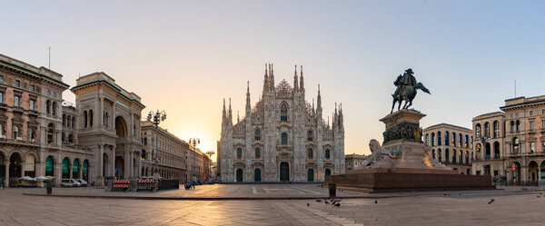 A panorama picture of the Piazza del Duomo at sunrise, with the Duomo di Milano or Milan Cathedral in the center, the Galleria Vittorio Emanuele II on the left, and the Vittorio Emanuele II statue on the right.