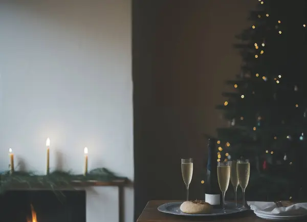 Champagne glasses with food and christmas tree in living room,interior lifestyle celebration new year in home