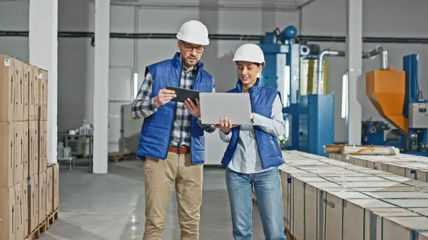 Two Caucasian Workers Wearing Uniforms Helmets While Standing Large Storage Stock Image