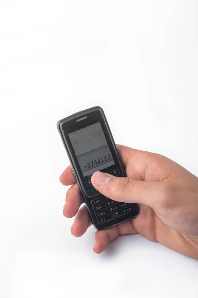 stock image hand holding a vintage mobile phone isolated on white background