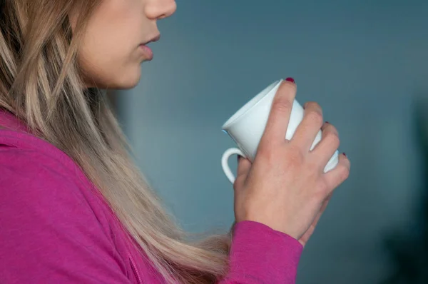 cropped shot of woman with cup of tea on grey background
