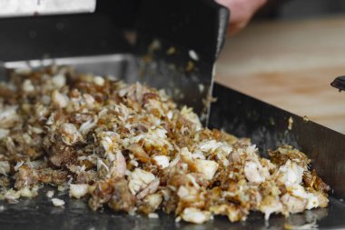 Man cutting prepared meat for Shawarma