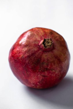 ripe pomegranate on a white background. selective focus. copy space.