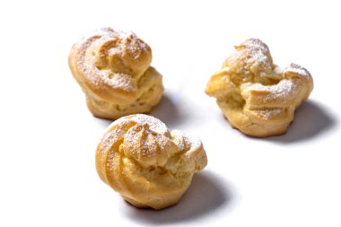 Decorating profiteroles with powdered sugar. 