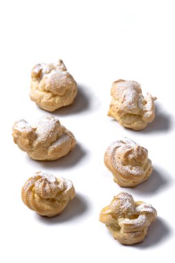 Decorating profiteroles with powdered sugar. 