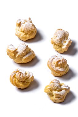 Decorating profiteroles with powdered sugar. 