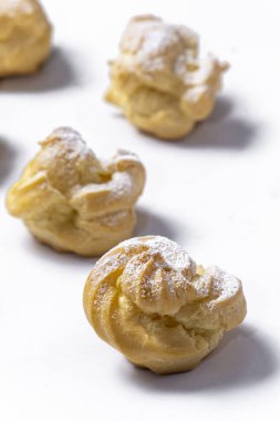 Decorating profiteroles with powdered sugar. 