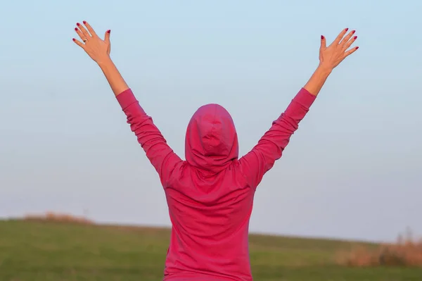 stock image young woman with raised hands outdoor