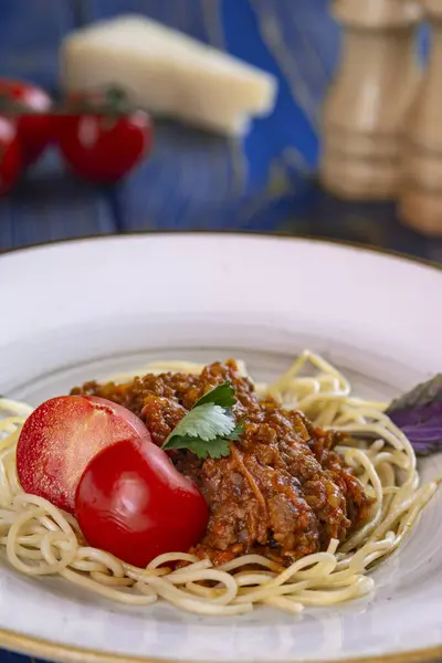 stock image italian Pasta bolognese with meat, tomato sauce and vegetables in blue wooden desk .