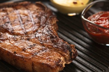 pork steak with vegetables in a black iron pan