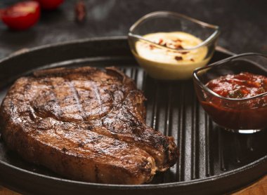 pork steak with vegetables in a black iron pan