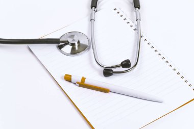 Üst görünüm doktor masası, not defteri ile doktor masasının yukarıdan çekilen, kalem, fotokopi alanı ile stetoskop düz döşeme ekran, üst görünüm fotoğraf projesi, tıp doktoru ve sağlık konsepti.