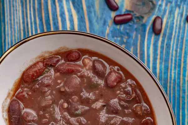 Healthy bean soup with red beans, Homemade Soup on blue wooden background , Vegetarian Food.