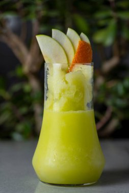 Refreshing summer cocktail with apple, orange and kiwi