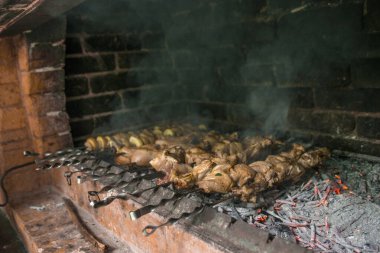 Gurme et ve sebzelerin ateş ve barbeküyle pişirildiği yakın çekim görüntüsü.