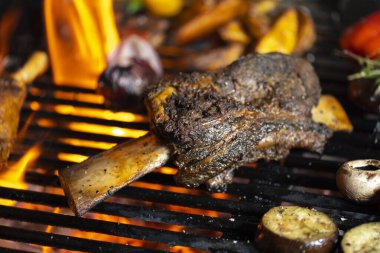 Kızarmış et ve sebzeler alevler ve sebzelerle ızgarada, yakın çekim.
