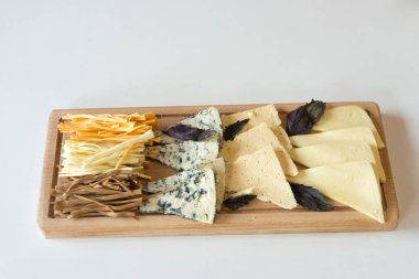 Tahtada farklı peynirler servis ediliyor. 