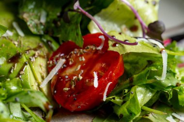 Fresh green salad with cherry tomatoes, arugula and olive oil