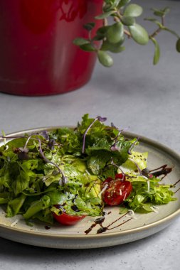 Fresh green salad with cherry tomatoes, arugula and olive oil