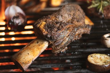 Kızarmış et ve sebzeler alevler ve sebzelerle ızgarada, yakın çekim.