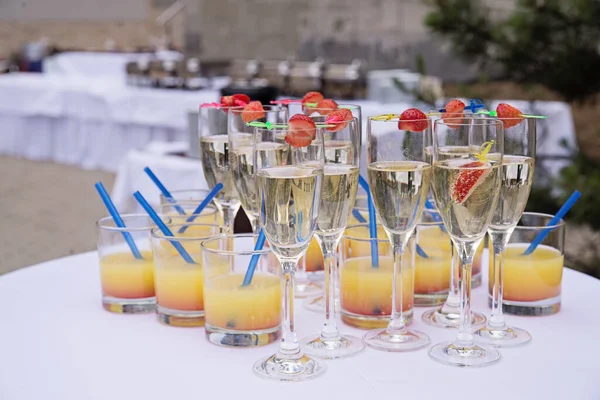 Glasses of champagne and juice welcome drinks on the table before the event