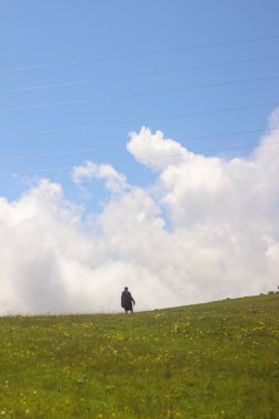One tourist against the backdrop of mountains and clouds in Gomismta, Guria, Georgia.