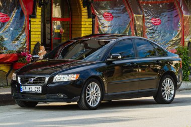  Side, Turkey -January 21, 2023:    black Volvo S40  is parked  on the street in city against the backdrop of a   shops