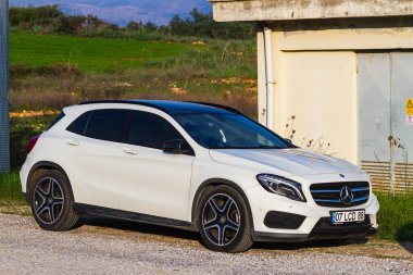 Side, Turkey -January 22, 2023:    white Mercedes-Benz A-class   is parked  on the street on a warm  day 