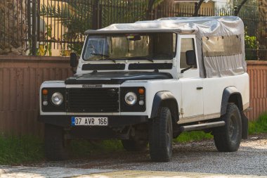 Side, Turkey -January 21, 2023:  white Land Rover Defender  parked on the street on a warm summer day 