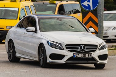 Side, Turkey -January 21, 2023:   white  Mercedes-Benz C-class,   front view.  New expensive sedan made in  Germany in autosalon
