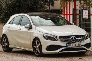 Side, Turkey -January 22, 2023:    white Mercedes-Benz A-class   is parked  on the street on a warm  day 