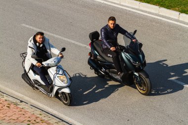 Side, Turkey -January 22, 2023:    motorcyclists   is driving fast on the street on a warm summer day 