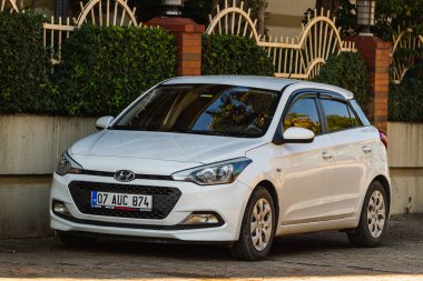 Side, Turkey  january 23 2023:   white  Hyundai i20  is parking  on the street on a  summer day  