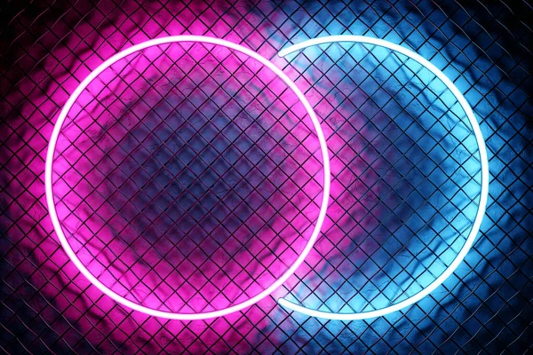 Glowing pink  and blue  neon lighting ellipse  on metal mesh  background.