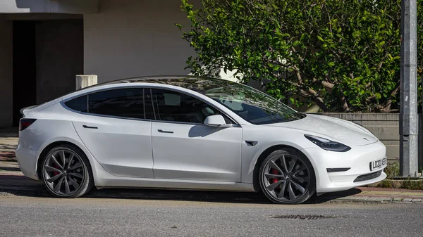 stock image Side, Turkey -February 05, 2023:     white Tesla Model 3  is parked  on the street on a warm  day  