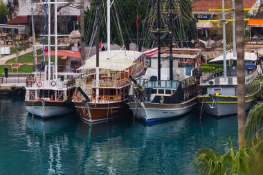 Manavgat, Türkiye - 05 Şubat 2023: turist seyahati için tekne su kanalına demirlendi. Küçük bir turist kasabasında küçük bir yat nehre bağlanır..