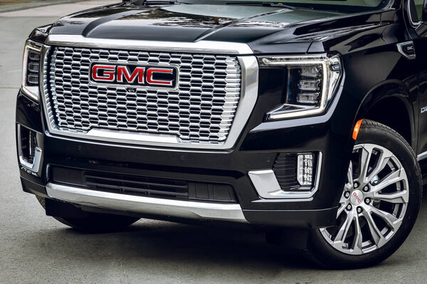  Novosibirsk, Russia - April  25, 2023: black GMC Yukon Denali,  Detail light close up of on new car. Exterior detail 